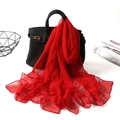 Elegant solid red georgette long scarf draped on a black handbag for sun protection - Red