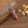 Polished red jasper hexagonal point pendant with a silver metal clasp on rustic fabric - Poppy Jasper