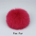 Detail shot of fluffy fuchsia fox fur pompom with soft texture for hat accessories - Fox Fur / Red