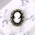 Vintage bronze cameo brooch with white female relief portrait and sparkling rhinestones - White Antique Bronze