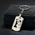 Macro view of silver stainless steel letter F keychain charm in a premium gift box - Letter F / Silver