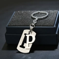 Silver stainless steel keychain with letter P detail hanging on a black jewelry gift box - Letter P
