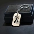Macro shot of silver letter Z keychain pendant in matte brushed metal on gift box foam - Letter Z