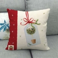 Linen Christmas pillowcase featuring festive gift box and tree illustrations on a sofa - Style 12
