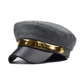 Detailed view of dark grey wool newsboy hat featuring a black leather brim and gold metal band - Gray