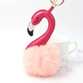 Close-up of pink pompom flamingo keychain with golden metal ring and premium PU leather - Pink