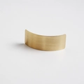 Close-up of a curved metal hair clip with a premium brushed gold finish and minimalist texture - Square Gold