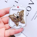 Detail of vintage gold butterfly brooch with colorful crystals on fashion display card - G16 Butterfly 03