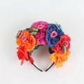 Detail of vibrant faux peonies and butterflies on a Mexican style party headband - Red Purple Orange Blue