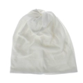Detailed view of white knitted ponytail beanie with top twist knot and soft ribbed texture - White
