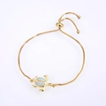Close-up of golden turtle bracelet with opal inlay and adjustable box chain - Gold Plated White Opal Turtle Bracelet