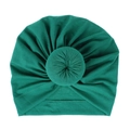 Detail of dark green knitted cotton baby hat with center donut knot and pleated texture - One Size / Dark Green