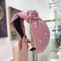 Pink knotted wide headband with pearls and rhinestones on soft fabric texture - Pink