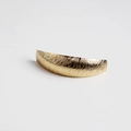 Detail of golden curved metal hair clip featuring a brushed texture and minimalist design - Brushed Gold