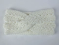 Detail of cream-white chunky knit headband with elegant twisted cross-weave pattern - White