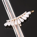 Detailed close-up of white teardrop pearls and golden alloy base hair clip decoration - Crown Bobby Pin