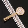 Macro detail of golden metal hair clip with white pearls forming a smiley face icon - Small Round Alloy Bobby Pin