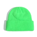 Neon green knitted beanie with thick ribbed texture shown in a flat lay minimalist style - Fluorescent Green