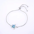 Detail of silver turtle bracelet featuring blue opal stone and adjustable box chain - White Gold Plated Blue Opal Turtle Bracelet