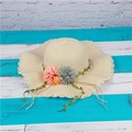 Summer woven straw sun hat with wavy brim and floral decor on a blue wooden background - M (56-58cm) / Beige