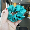 Lustrous emerald green satin scrunchie with smooth silk texture for elegant hairstyles - Cyan