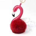 Detailed view of pink flamingo keychain with a soft red faux fur pompom and gold ring - Burgundy