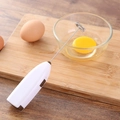 White handheld electric milk frother and egg whisker on a wooden cutting board - Boxed White