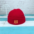 Red ribbed knit beanie for men and women featuring yellow embroidered stripe details - Red