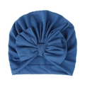 Vista ravvicinata di un cappello a turbante blu per neonati in cotone a maglia con fiocco. - Blu jeans
