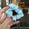 Elegant light blue satin scrunchie with silky luster and soft pleated fabric texture - Sky Blue