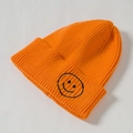 Orange knitted beanie with a classic black smiley face embroidery for kids and parents - Core Spinning / Orange
