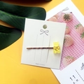 Yellow acrylic gummy bear hair clip on white card with a minimalist aesthetic design - Yellow