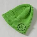 Children's knitted green beanie with ribbed texture and black smiley face embroidery - Core Spinning / Grass Green