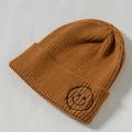 Caramel knitted beanie hat for kids featuring a black embroidered smiley face patch - Core Spinning / Coffee