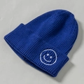 Royal blue knitted beanie for kids featuring a minimalist white embroidered smiley face - Core Spinning / Sapphire Blue