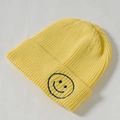 Kids yellow knit beanie with black embroidered smiley face on a ribbed texture - Core Spinning / Bright yellow