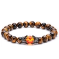 Macro detail of brown tiger eye stone bracelet with micro-pave crown and red bead - Yellow Tiger Eye