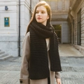 Thick black hand-knit scarf for women in chunky knit texture worn in urban setting - Black