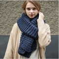 Thick knit wool scarf in classic blue color for women shown on a model - Navy Blue