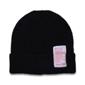 Detailed close-up of a black ribbed knit beanie featuring a vintage white textile label - Black