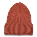Close-up of rust red knit beanie showing thick rib texture and soft yarn detail - Caramel