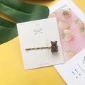 Brown acrylic jelly bear hair clip on a white decorative card with green leaves - Coffee