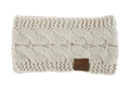 Detail of cream cable knit winter headband showing thick yarn texture and leather logo tag - Beige