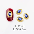 Close-up of vintage oval nail art charms with blue gems and gold base, 7.7x10.3mm size - 2543 Gold Royal Blue