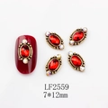 Macro view of LF2559 oval nail art charms with red rhinestones and vintage gold alloy - 2559 Red