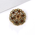 Vintage style round alloy brooch with brown rhinestones and filigree design on white background - Round Hollow - Amber Rhinestone (XD633-4)