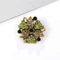 Vintage style gold flower brooch with sparkling green rhinestones on white surface - Gold Vintage - Green Rhinestone (XD5455-1)