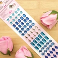 Blue and silver 3D crystal gem stickers with stars and drops on a wooden background - Blue Waterdrop