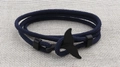 Detailed view of a dark blue braided cord bracelet featuring a black whale tail clasp - Black Whale Tail Buckle / Navy Blue