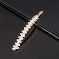 Detailed macro view of white faux pearls inlaid on a gold alloy hair clip on black surface - 12-Small Flowers Curved Bobby Pin